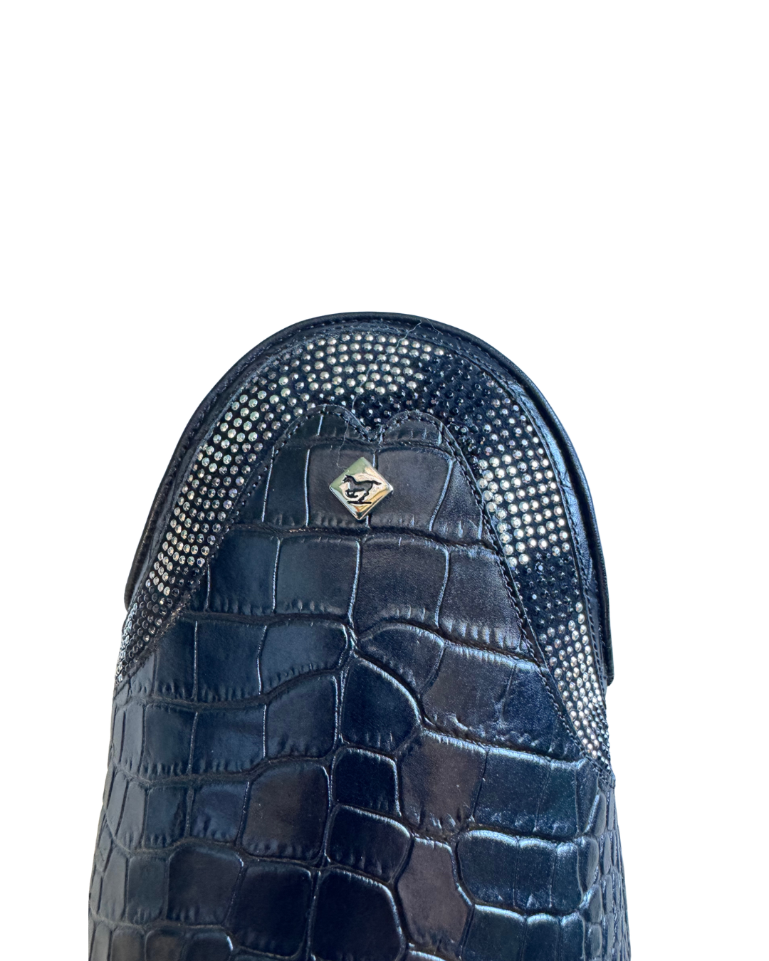 Close-up of a  black crocodile-embossed leather top of DeNiro boot with a textured mesh upper and a small metallic logo badge, set against a plain white background.