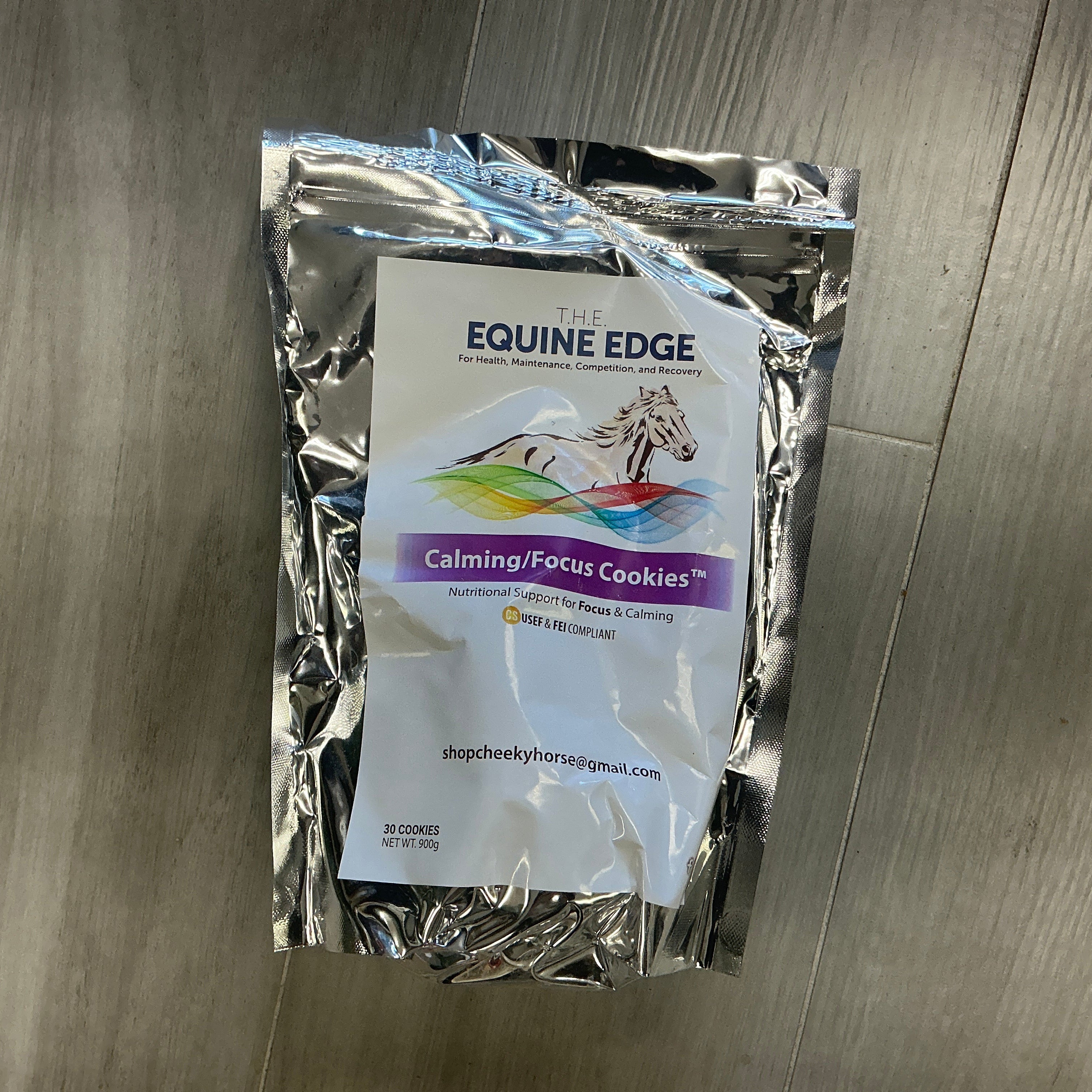 Package of Equine Edge Calming/Focus Cookies on a wooden surface